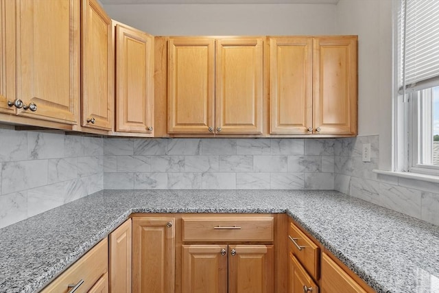 49-51 Fairmount Ave, Somerville, MA 02144 - kitchen featuring tasteful backsplash, light stone countertops, and light brown cabinets