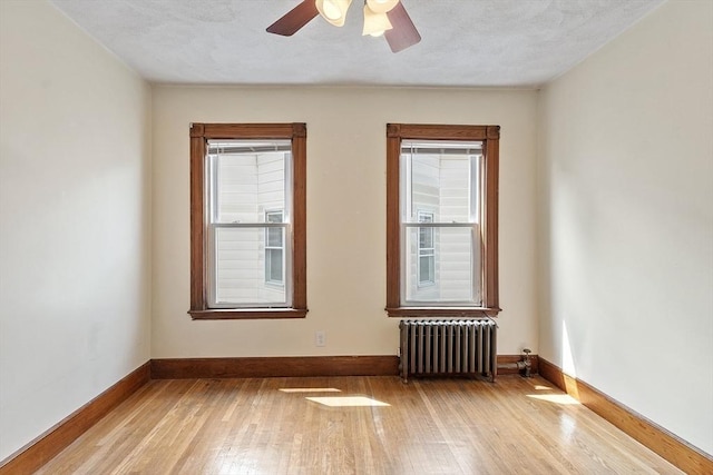 49-51 Fairmount Ave, Somerville, MA 02144 - spare room featuring radiator heating unit, wood-type flooring, baseboards, and ceiling fan