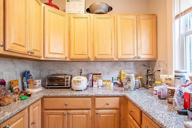 49-51 Fairmount Ave, Somerville, MA 02144 - kitchen featuring decorative backsplash and light stone counters
