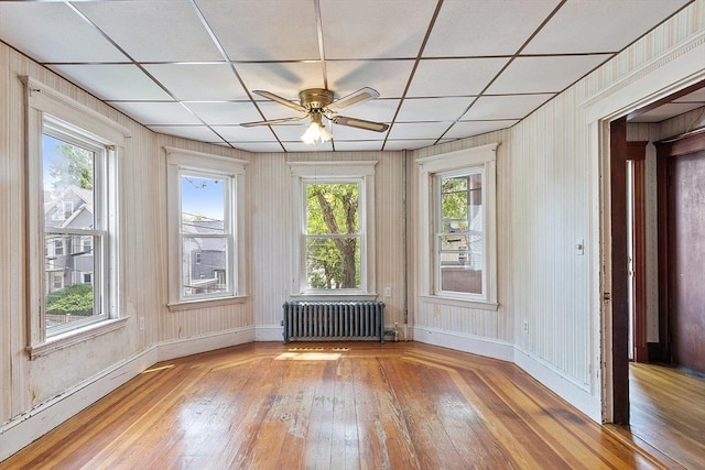 49-51 Fairmount Ave, Somerville, MA 02144 - spare room with radiator, hardwood / wood-style floors, ceiling fan, baseboards, and a paneled ceiling