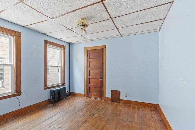 49-51 Fairmount Ave, Somerville, MA 02144 - spare room with radiator, wood finished floors, a drop ceiling, and baseboards