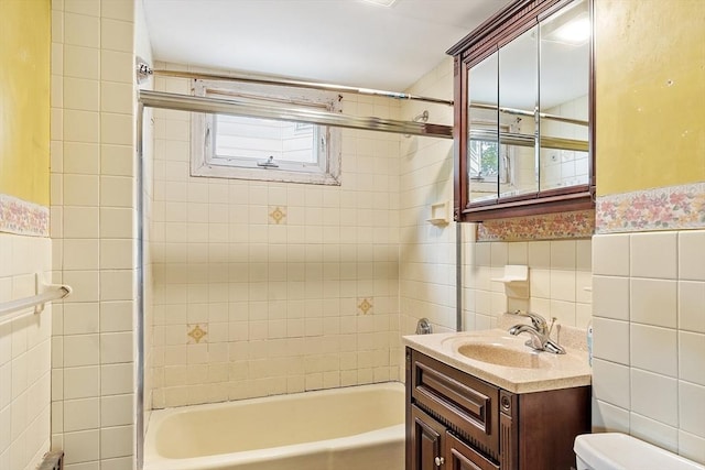 49-51 Fairmount Ave, Somerville, MA 02144 - full bath featuring tile walls, toilet, vanity, healthy amount of natural light, and tub / shower combination