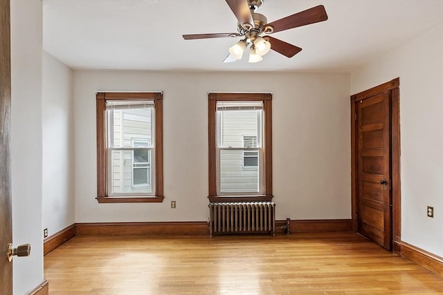 49-51 Fairmount Ave, Somerville, MA 02144 - empty room with radiator, light wood-style floors, baseboards, and ceiling fan