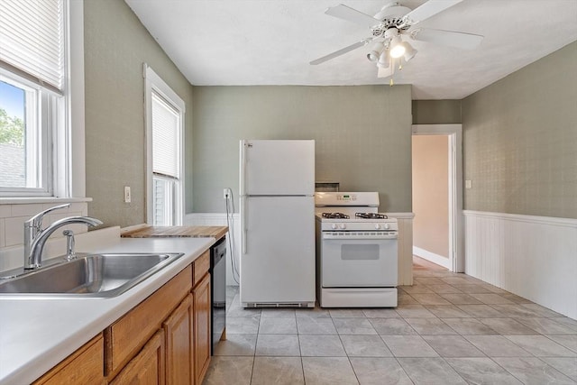 49-51 Fairmount Ave, Somerville, MA 02144 - kitchen featuring white appliances, a sink, brown cabinetry, light countertops, and a ceiling fan