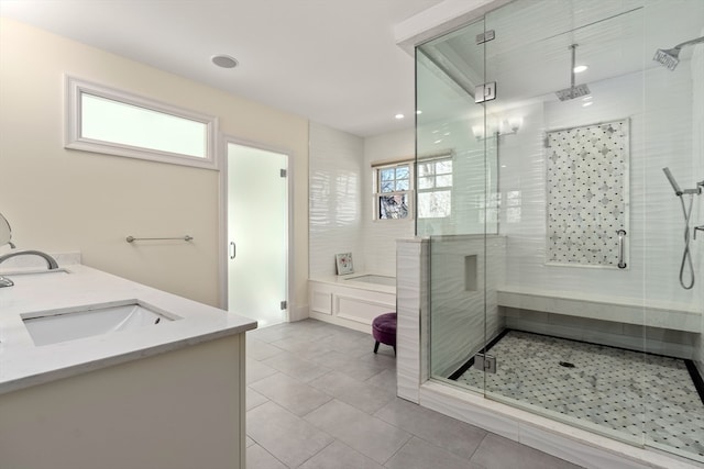 bathroom with vanity, tile patterned floors, and plus walk in shower