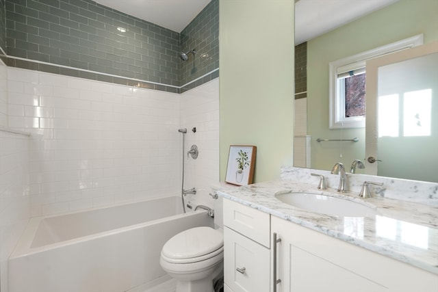 full bathroom featuring vanity, toilet, and tiled shower / bath