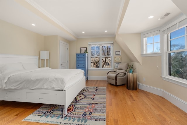 bedroom with light hardwood / wood-style floors and ornamental molding