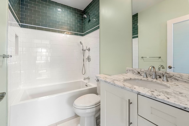 full bathroom featuring tiled shower / bath, vanity, and toilet