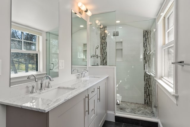 bathroom featuring lofted ceiling, tile patterned flooring, an enclosed shower, and vanity