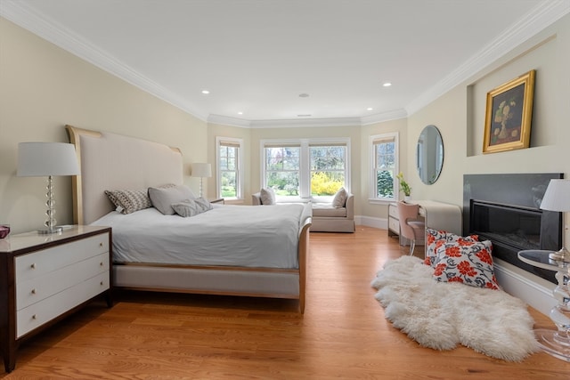 bedroom featuring light wood-type flooring and crown molding