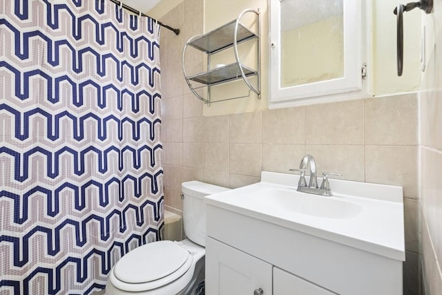 full bathroom with tile walls, toilet, vanity, and shower / tub combo with curtain