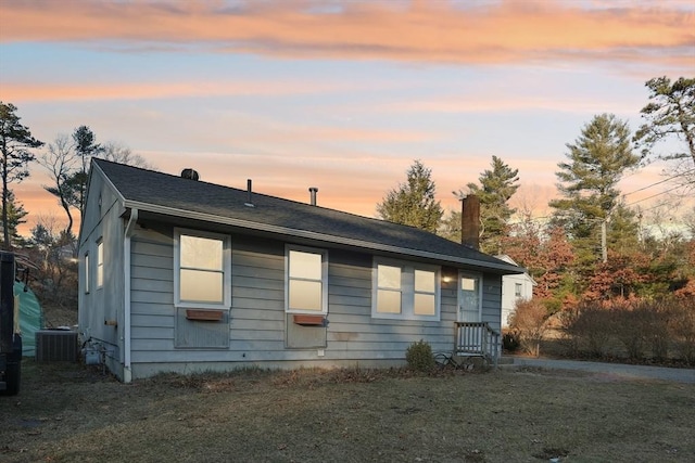 exterior space with a lawn and central AC