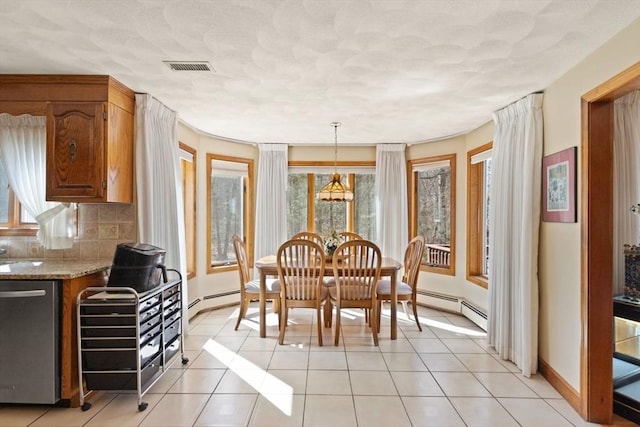 dining space featuring light tile patterned floors, baseboards, visible vents, a textured ceiling, and baseboard heating