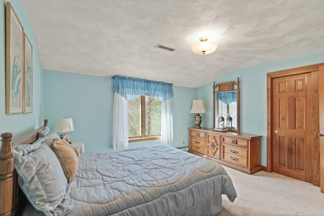 carpeted bedroom featuring visible vents, baseboard heating, a textured ceiling, and lofted ceiling