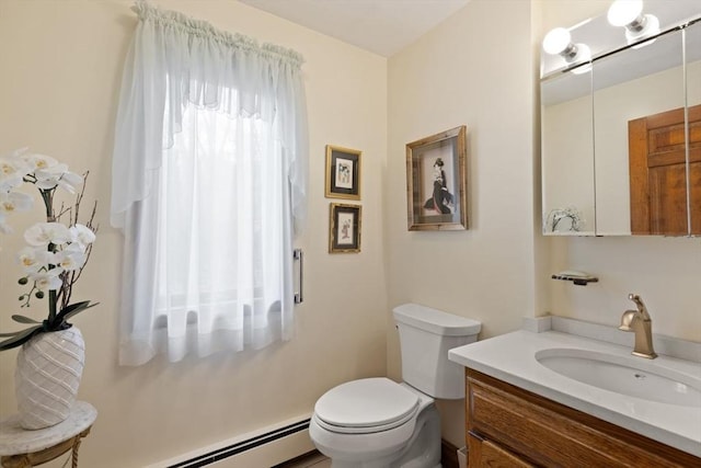 bathroom featuring toilet, baseboard heating, and vanity