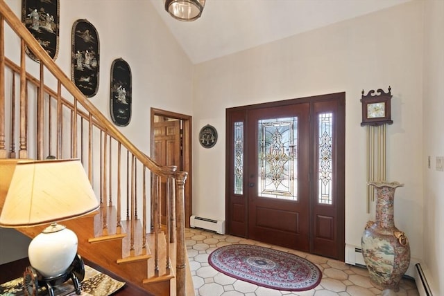 foyer with a baseboard heating unit, stairs, and high vaulted ceiling