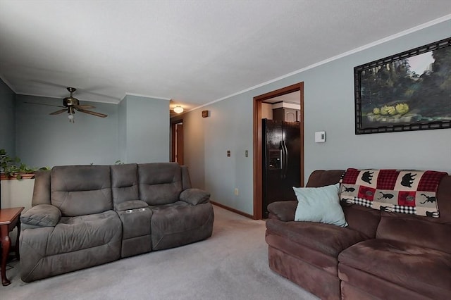 living area featuring ceiling fan, carpet floors, ornamental molding, and baseboards