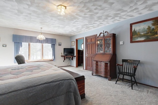 bedroom with a textured ceiling and light colored carpet