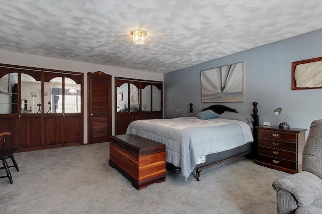 bedroom with carpet floors and a textured ceiling