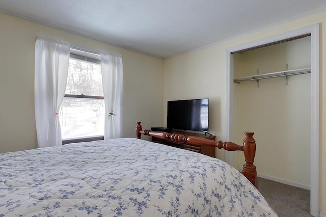 carpeted bedroom featuring a closet and baseboards