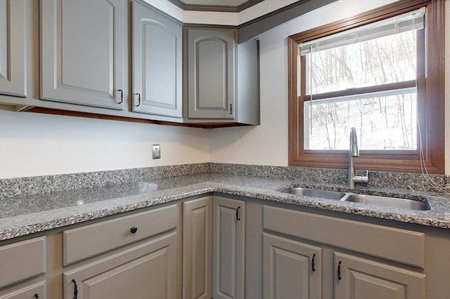 kitchen with gray cabinets and a sink