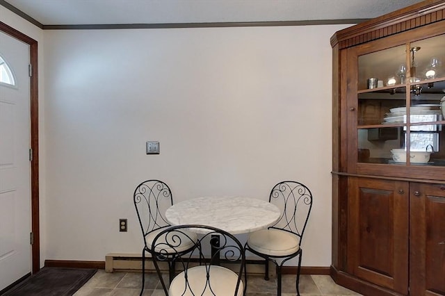 dining area with light tile patterned floors, baseboards, and crown molding