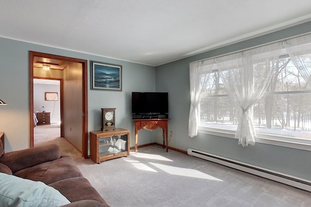 carpeted living room featuring baseboards, ornamental molding, a baseboard radiator, and a healthy amount of sunlight