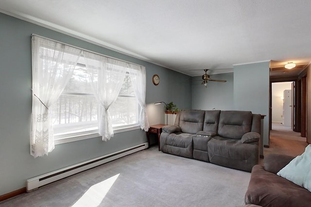 carpeted living area with ceiling fan and baseboard heating