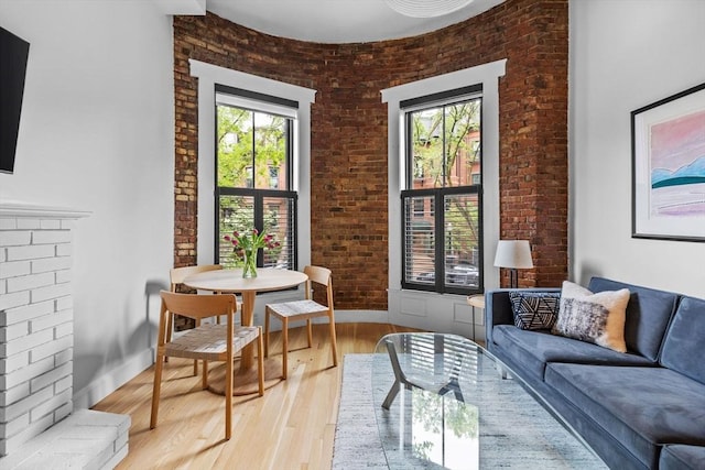 26 Concord Sq Unit 2, Boston, MA 02118 - living room featuring light wood finished floors and brick wall