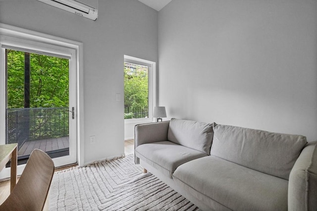 26 Concord Sq Unit 2, Boston, MA 02118 - living area with wood finished floors, an AC wall unit, and baseboards