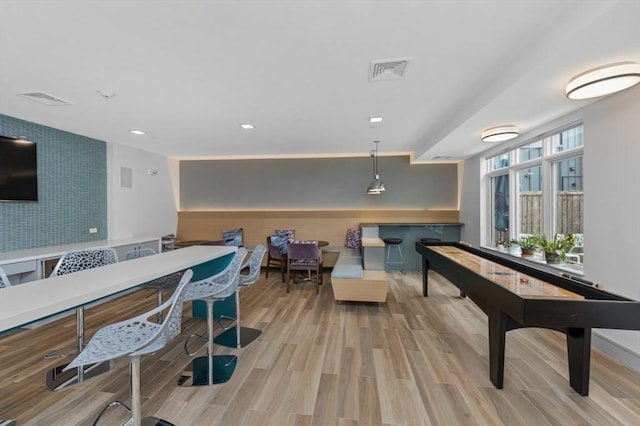 180 Telford St Unit 614, Boston, MA 02135 - recreation room with an accent wall, wood finished floors, and recessed lighting