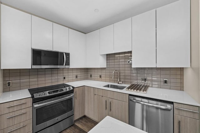 180 Telford St Unit 614, Boston, MA 02135 - kitchen featuring stainless steel appliances, a sink, light countertops, dark wood-type flooring, and tasteful backsplash