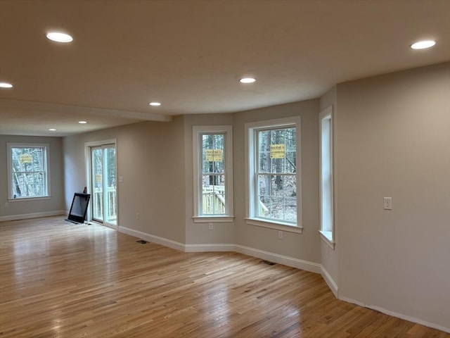 unfurnished room featuring a wealth of natural light and light wood-type flooring