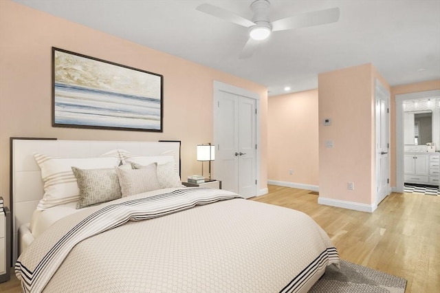 140 Main St Unit E, Amesbury, MA 01913 - bedroom featuring light wood-type flooring, a closet, baseboards, ensuite bath, and ceiling fan