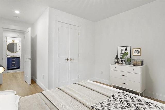 140 Main St Unit E, Amesbury, MA 01913 - bedroom with light wood finished floors, baseboards, and a closet