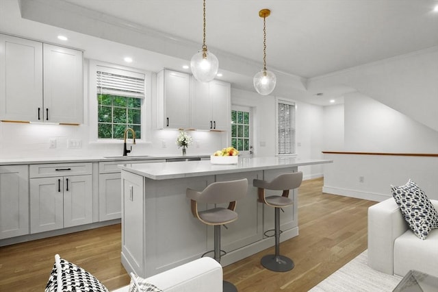 140 Main St Unit E, Amesbury, MA 01913 - kitchen with a sink, ornamental molding, backsplash, light wood-type flooring, and recessed lighting