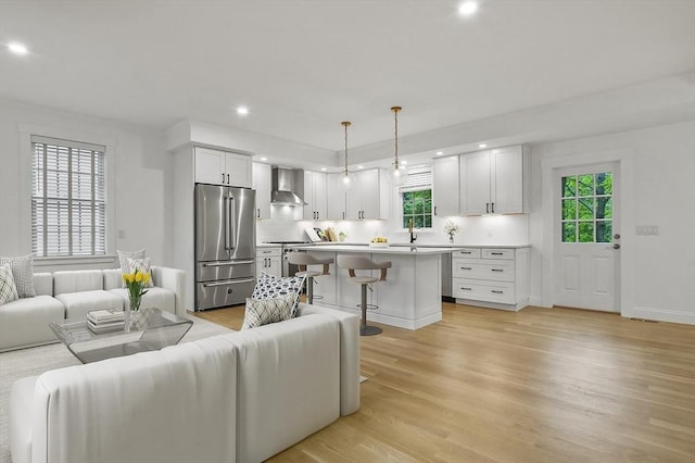 140 Main St Unit E, Amesbury, MA 01913 - living room featuring plenty of natural light, light wood-style floors, recessed lighting, and baseboards