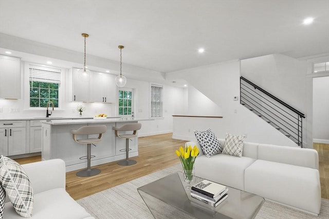 140 Main St Unit E, Amesbury, MA 01913 - living room featuring light wood-style flooring, recessed lighting, stairway, and baseboards