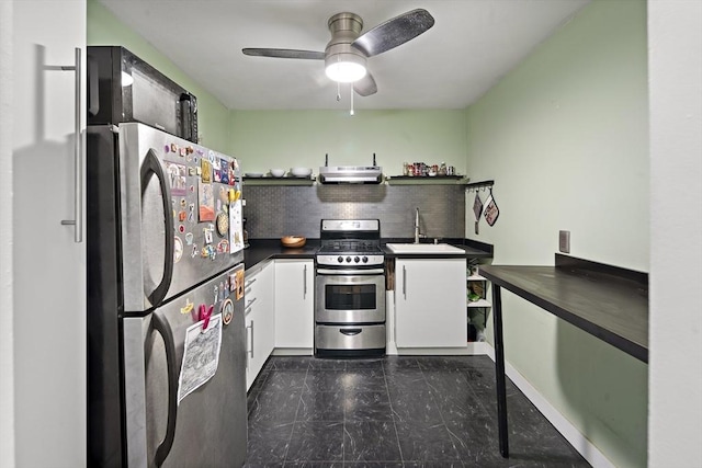 32 Whites Ave Unit D65, Watertown, MA 02472 - kitchen featuring appliances with stainless steel finishes, a sink, dark countertops, under cabinet range hood, and white cabinetry