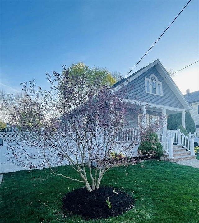 15 Bates Rd, Framingham, MA 01702 - view of front facade with a porch and a front lawn