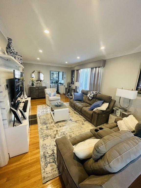 15 Bates Rd, Framingham, MA 01702 - living area with ornamental molding, light wood finished floors, and recessed lighting