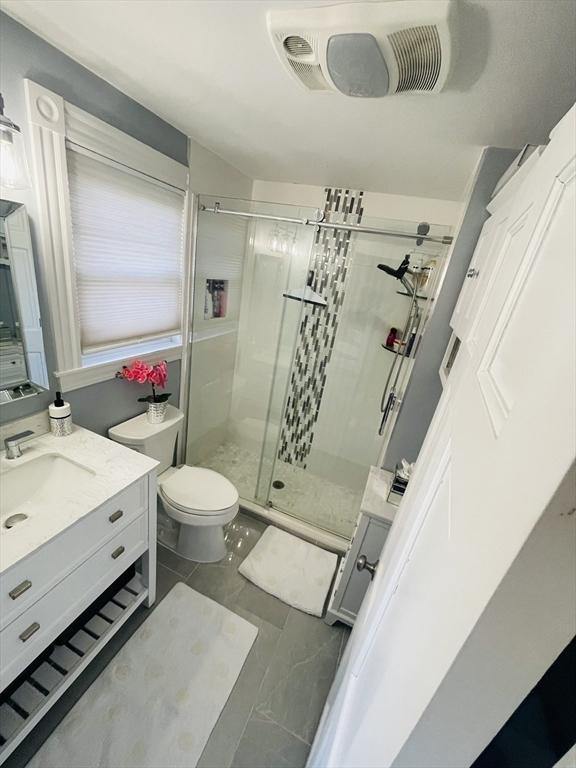 15 Bates Rd, Framingham, MA 01702 - full bathroom with toilet, visible vents, a shower stall, marble finish floor, and vanity