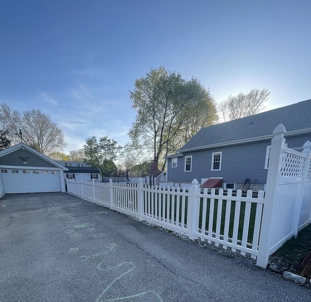 15 Bates Rd, Framingham, MA 01702 - view of side of property featuring a fenced front yard and a garage