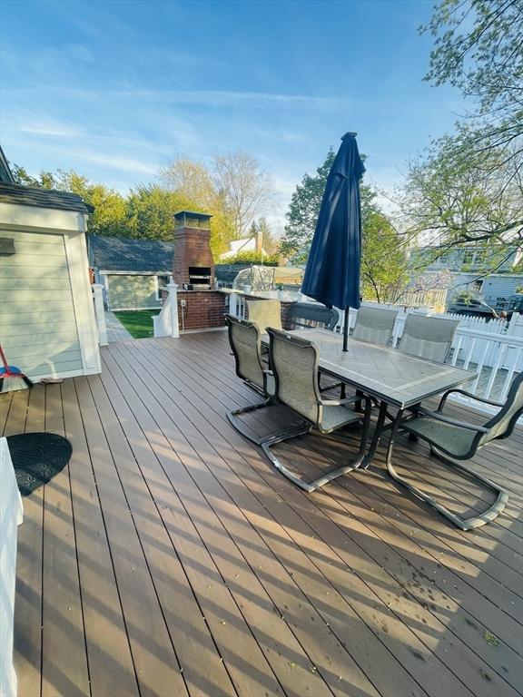 15 Bates Rd, Framingham, MA 01702 - wooden terrace featuring an outdoor fireplace and outdoor dining space