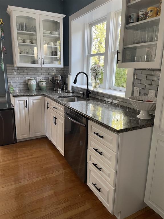 15 Bates Rd, Framingham, MA 01702 - bar featuring backsplash, dishwashing machine, dark wood finished floors, and a sink