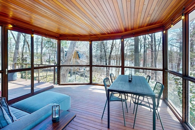 sunroom / solarium with outdoor dining space