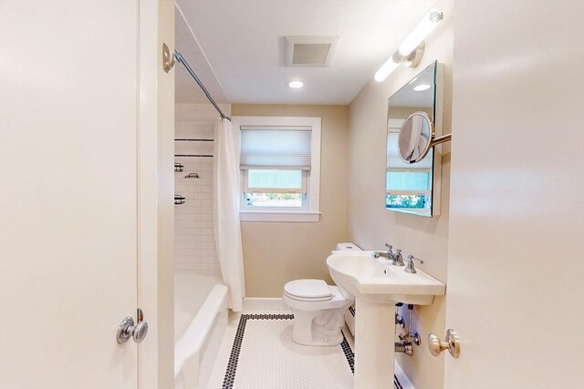 full bath with tile patterned flooring, toilet, baseboards, visible vents, and shower / tub combo