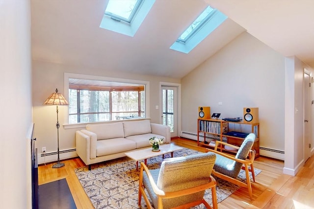 living area featuring high vaulted ceiling, a skylight, light wood-style flooring, and a baseboard radiator