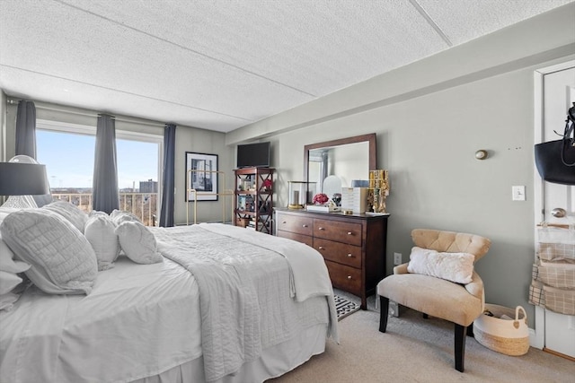 bedroom featuring light colored carpet and a textured ceiling