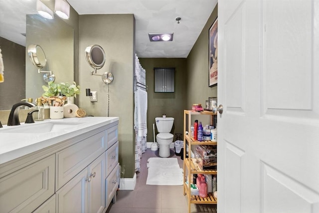 bathroom with tile patterned floors, toilet, vanity, and a shower with curtain